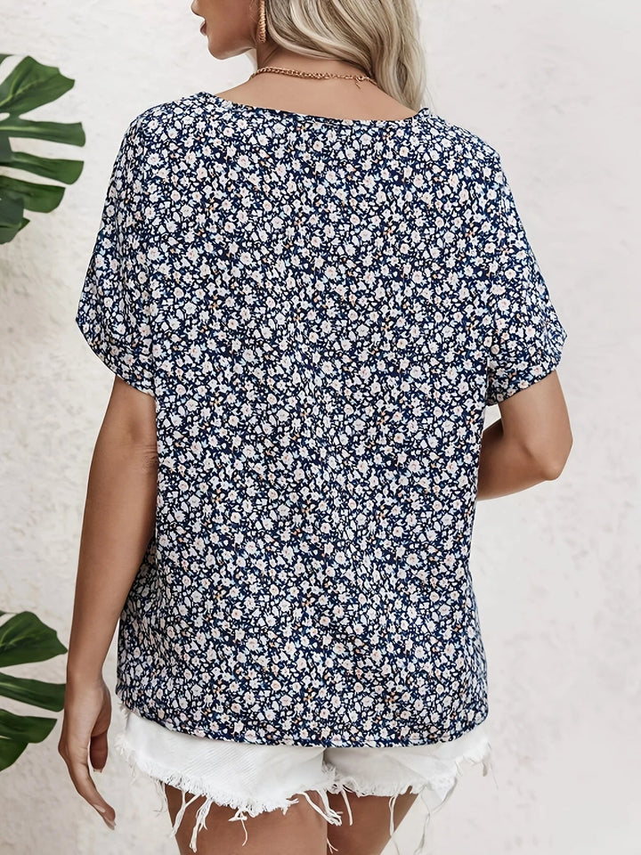 Close-up of navy blue floral blouse showing delicate print and button-up front detail