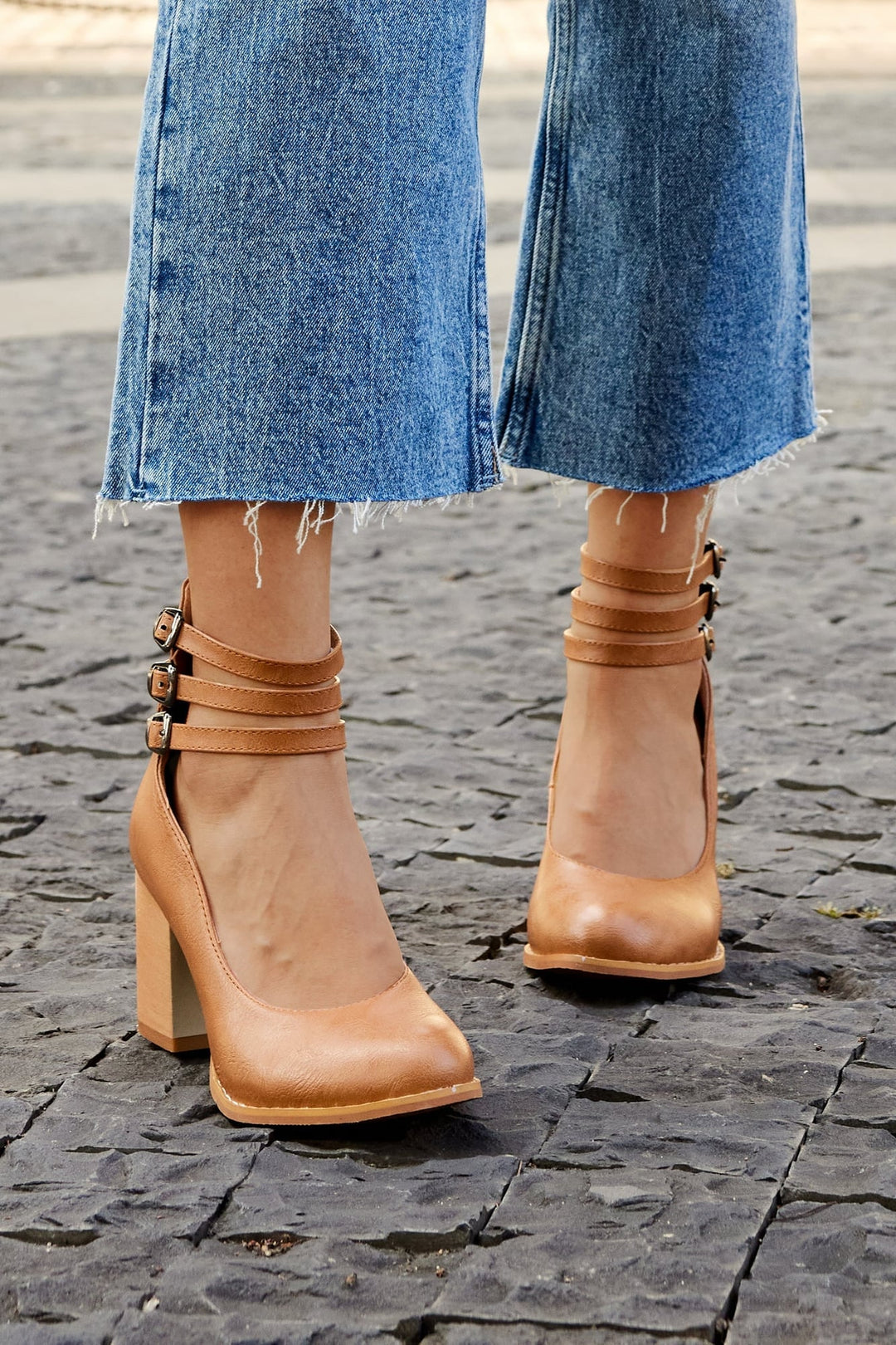 Model wearing Casilda brown ankle strap sandals with tailored trousers