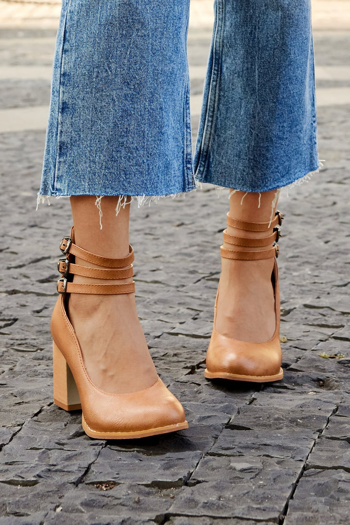 Model wearing Casilda brown ankle strap sandals with tailored trousers