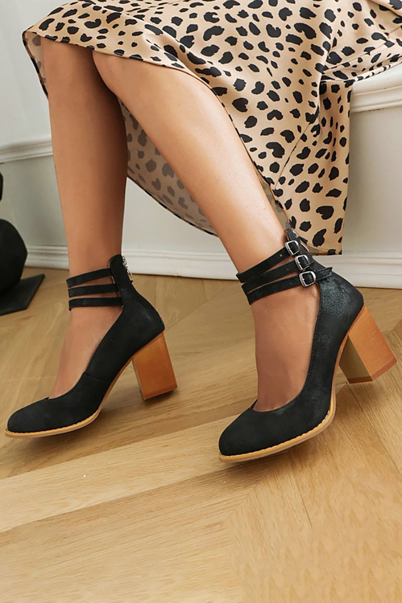 Model wearing Casilda black block heel sandals with a flowy midi dress