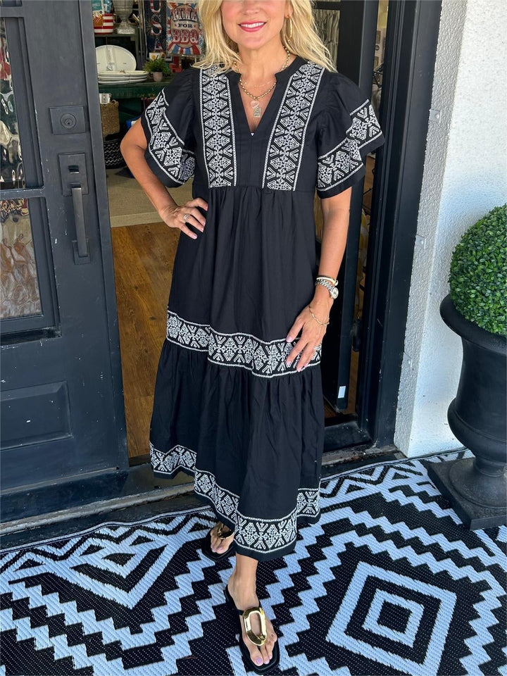 Woman wearing the Cassandra boho flowy loose fit dress in black, front view