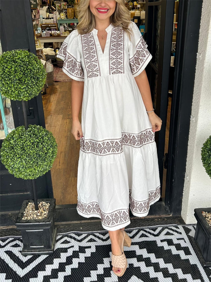 Woman wearing the Cassandra boho flowy loose fit dress in white, front view