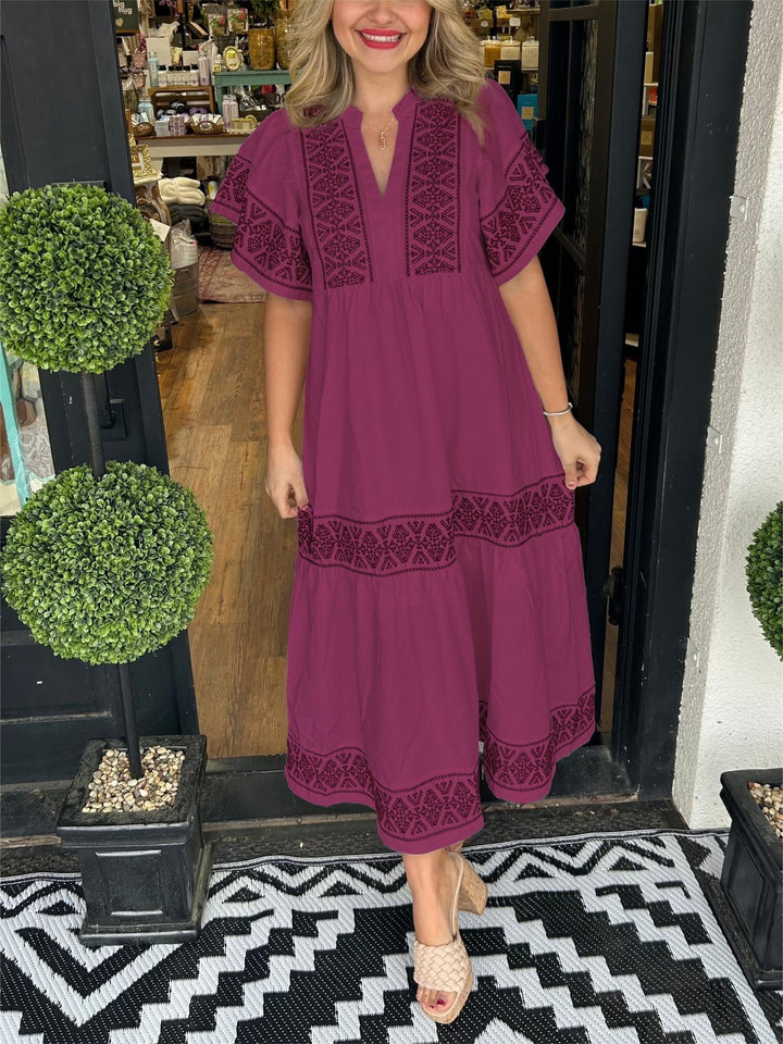 Woman wearing the Cassandra dress in wine red, styled with sandals
