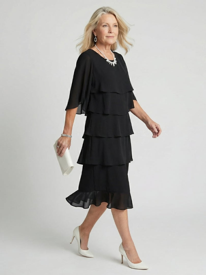 Front view of the Cassia midi dress in black showing tiered skirt layers and delicate flutter sleeves