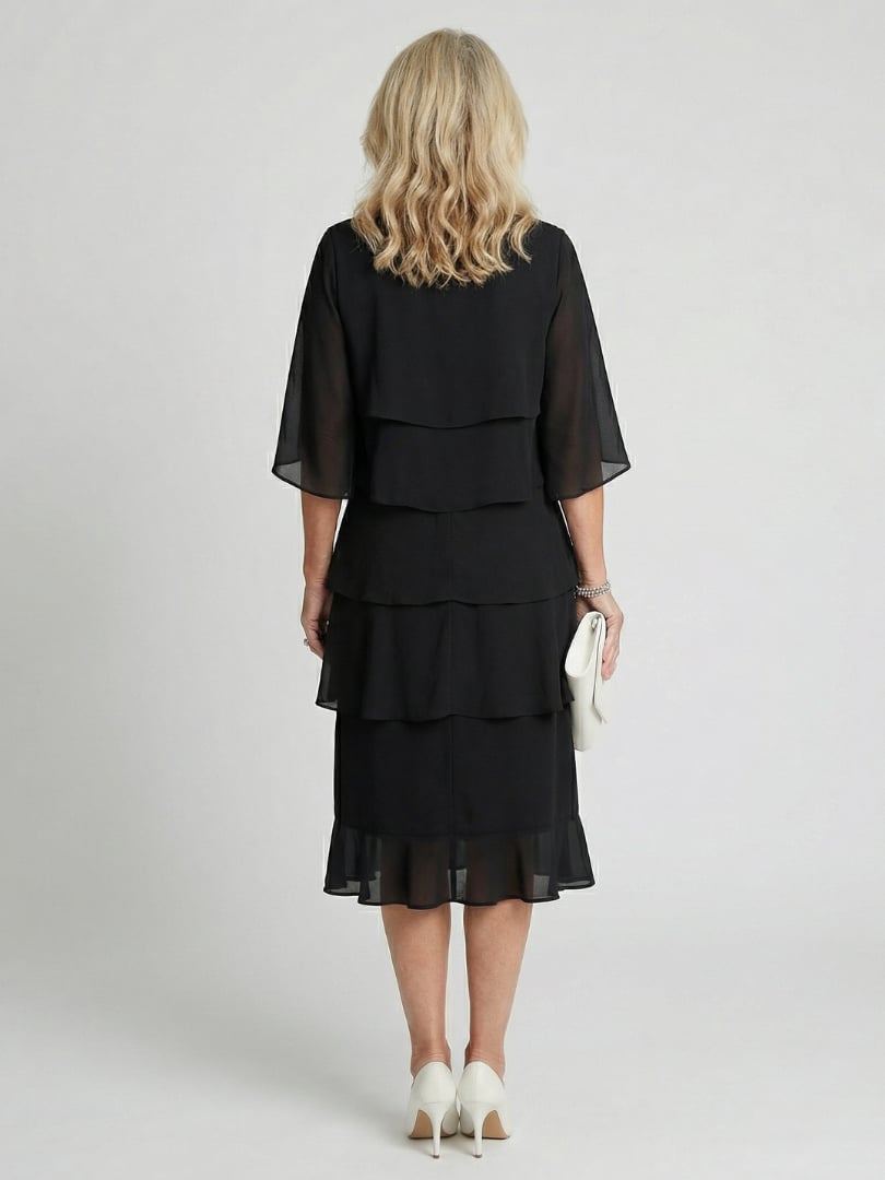 Close-up of flutter sleeve detail and round neckline on the Cassia midi dress in black