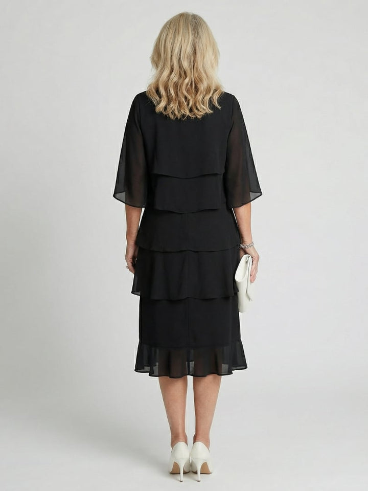 Close-up of flutter sleeve detail and round neckline on the Cassia midi dress in black