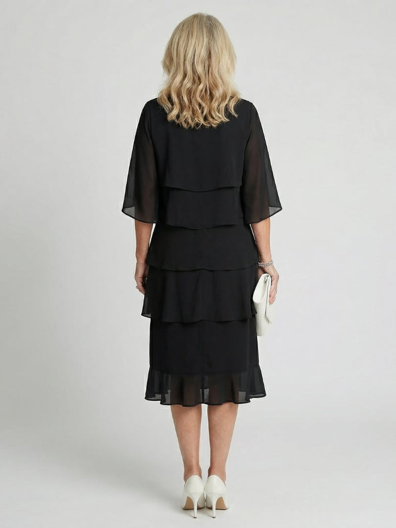 Close-up of flutter sleeve detail and round neckline on the Cassia midi dress in black