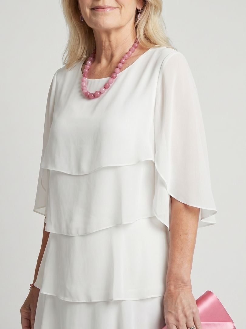 Close-up of tiered skirt hem detail on the light blue Cassia midi dress