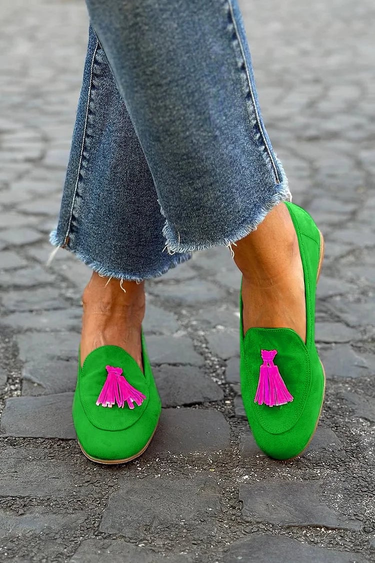 Green tassel accent loafers with a sleek silhouette and delicate tassel detail at the vamp, shown from a front-angle view