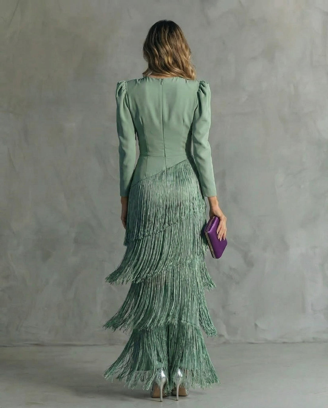 Close-up of tiered fringe detailing on the Cassiopeia maxi dress in green