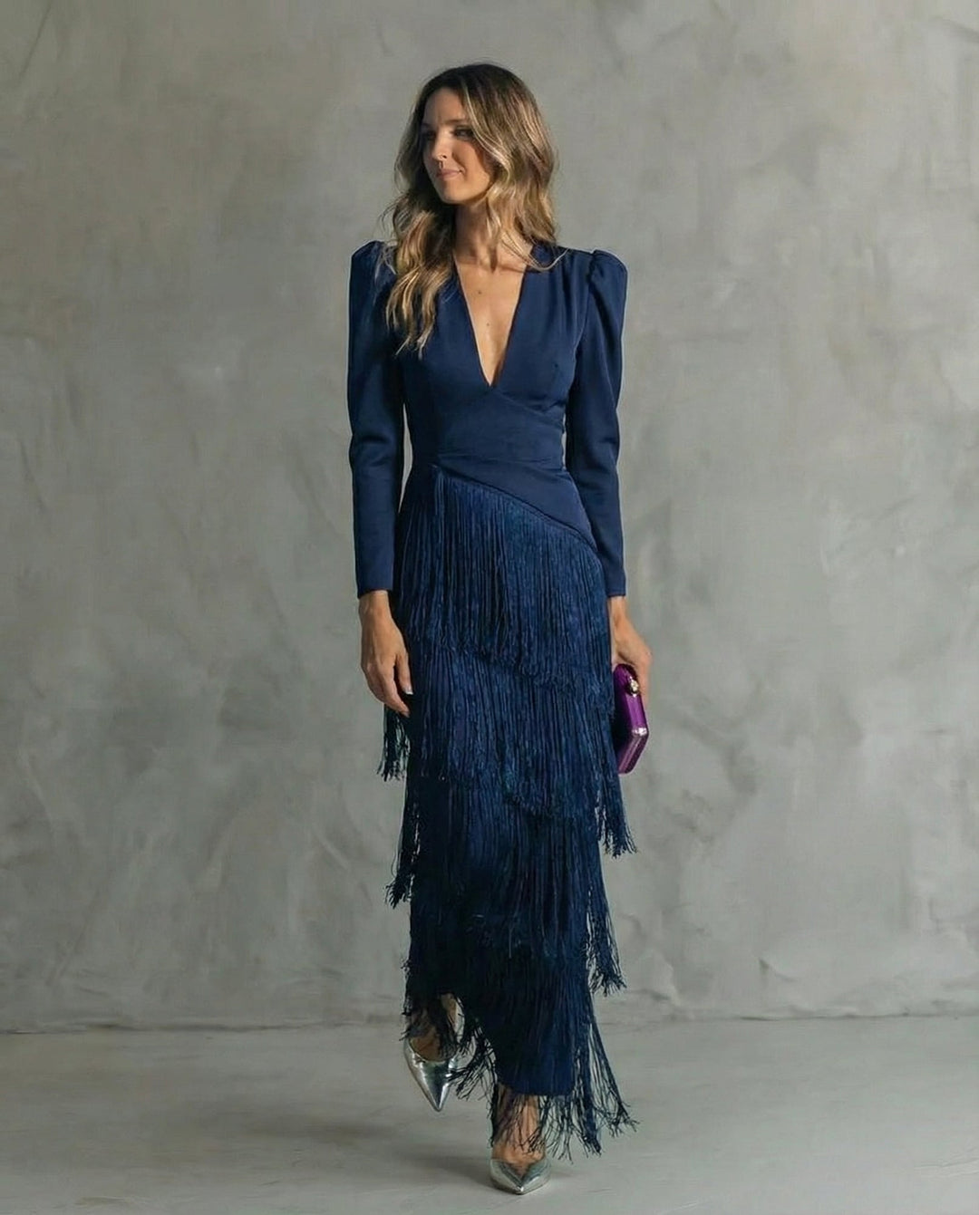 Model wearing Cassiopeia V neck fringe maxi dress in blue, back view showing long sleeve detail
