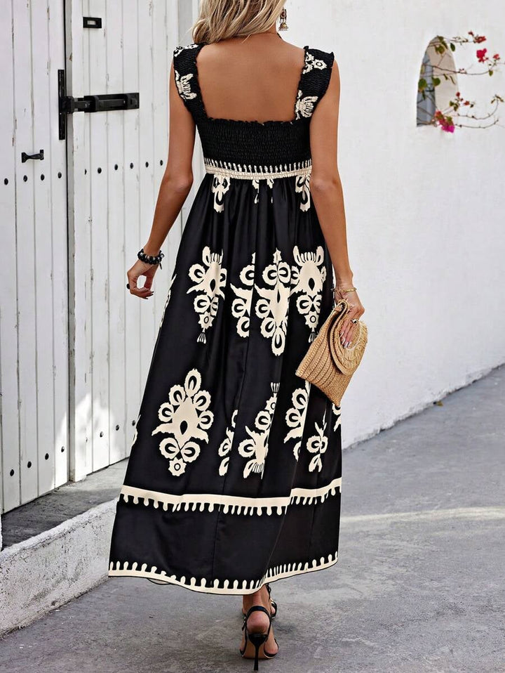 Lifestyle shot of woman in the Catalina printed dress in cream at a sunny outdoor setting