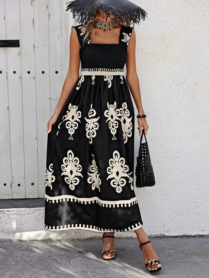Flat lay of the Catalina square neck printed dress in black showing the overall print and cut