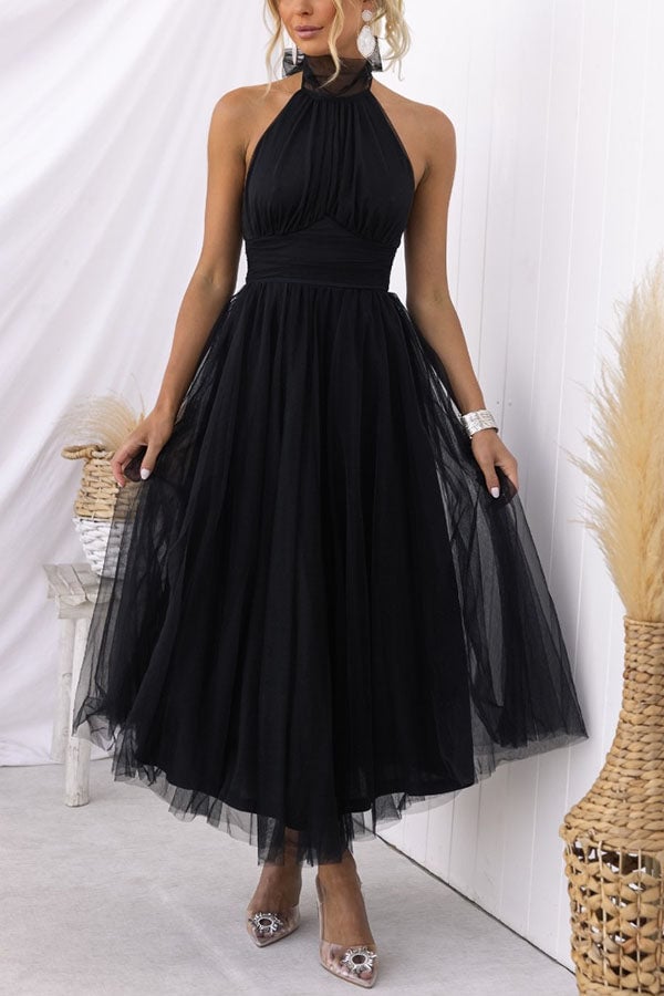 Model wearing the Catalina tulle dress in red at a wedding reception setting