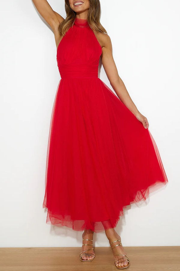 Model in the Catalina dress in black tulle styled with heeled sandals for a formal event