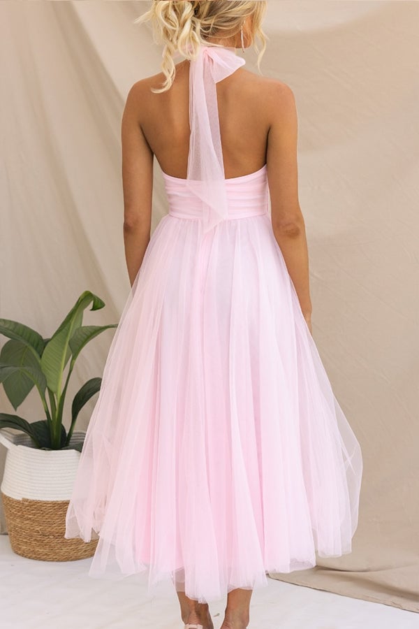 Model wearing the Catalina tulle dress in white with flowing floor-length skirt