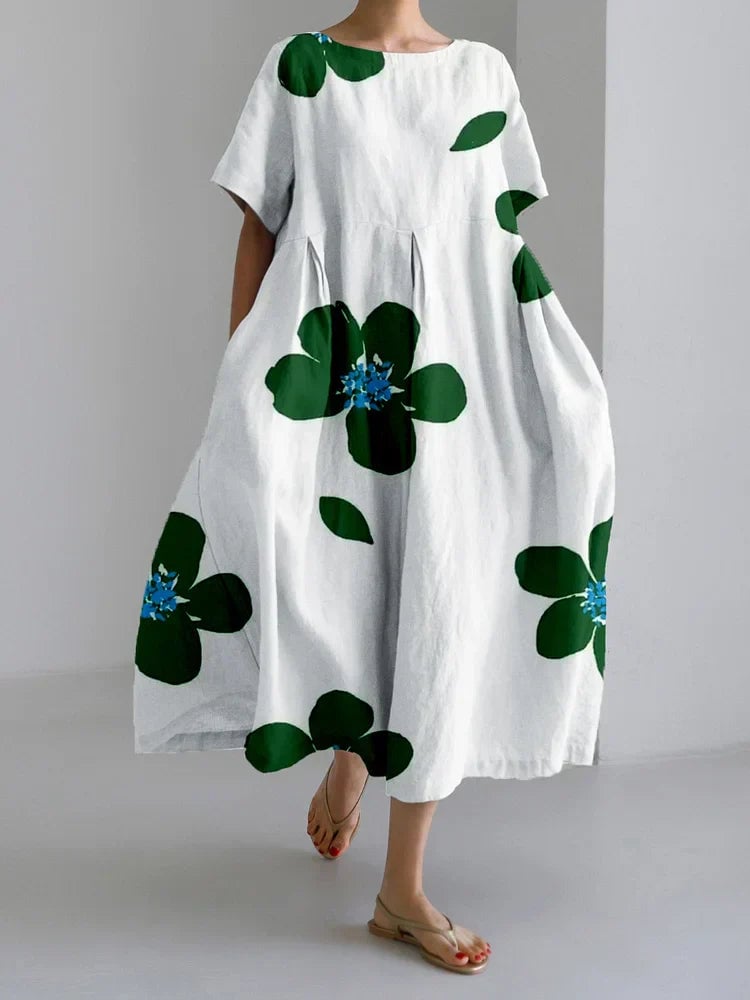 Side view of the Caterina long summer dress highlighting the flattering pleats and full-length hem