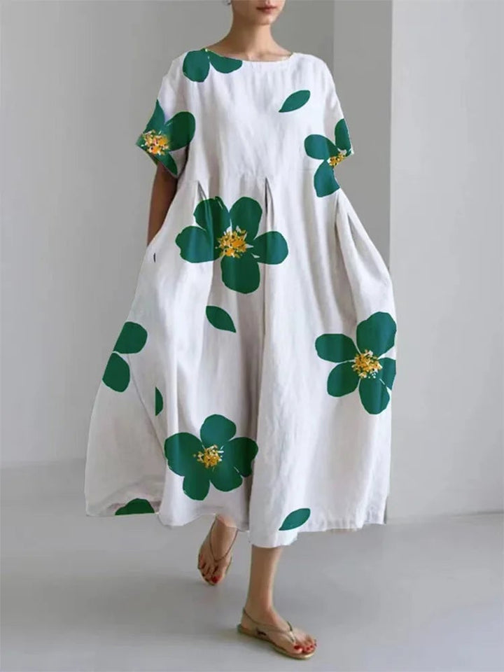Close-up detail of the Caterina dress floral print fabric in green colorway showing vibrant colors and soft texture
