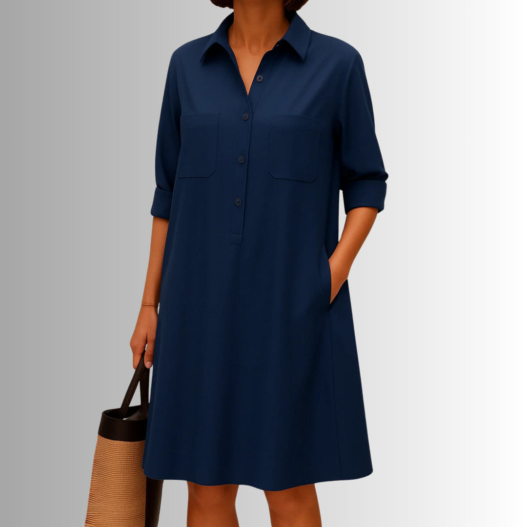 Woman in a lightweight button dress with rolled three-quarter sleeves strolling outdoors in white