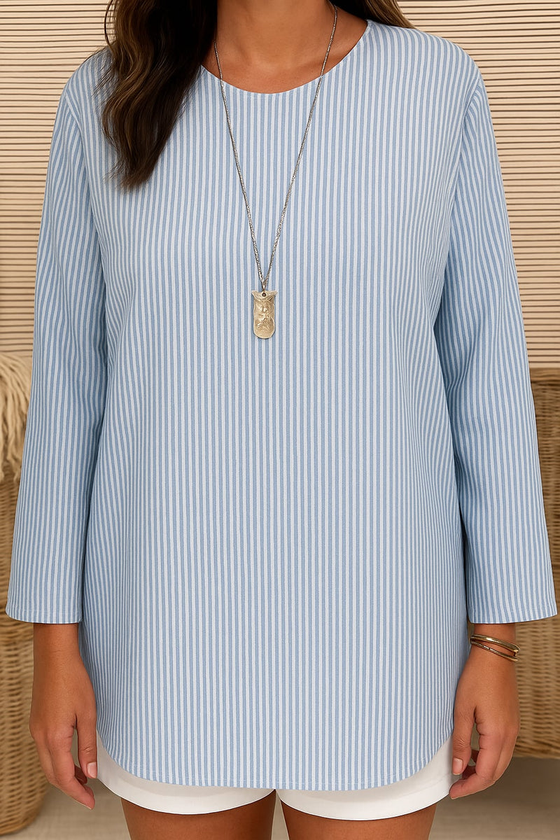 Model wearing the Cecilia striped blouse tucked into high-waisted pants for a polished look