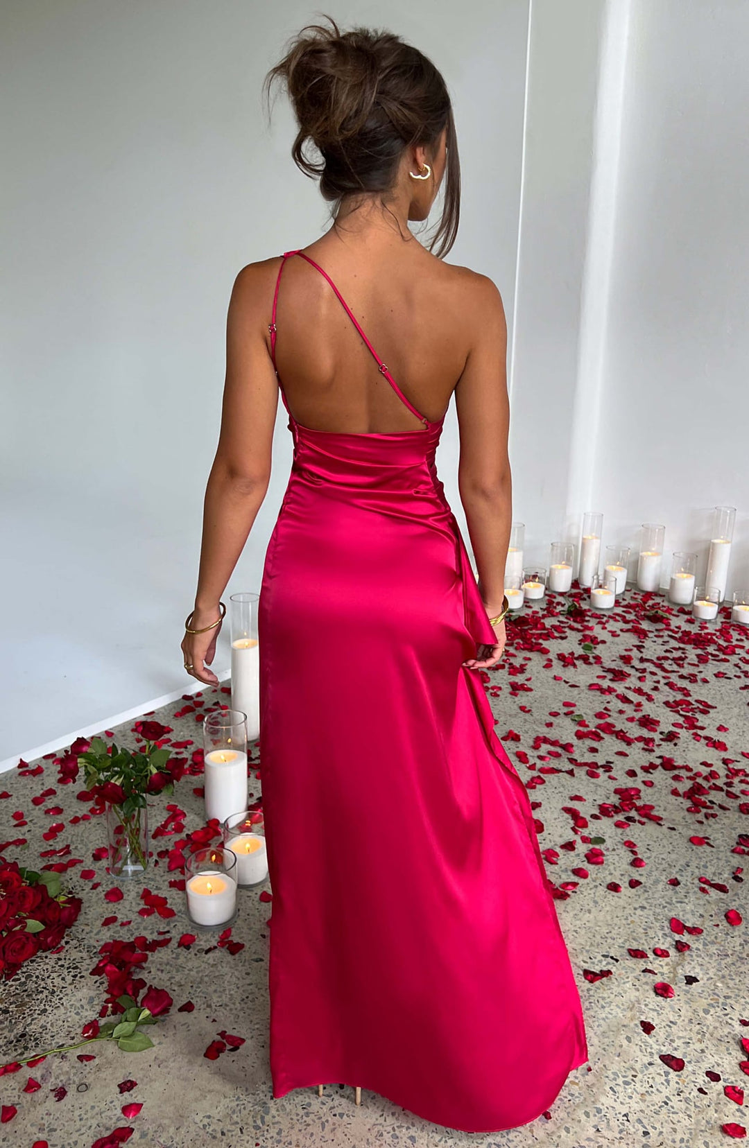 Woman wearing the Celeste navy blue satin one-shoulder bodycon dress, full-length front view