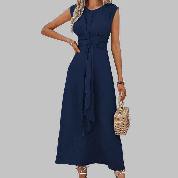 Celeste midi dress in blue worn with minimal gold jewelry for an elegant evening look
