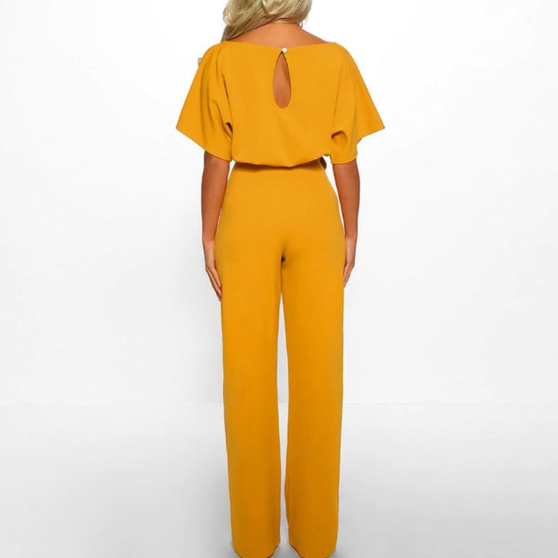 Woman wearing the Celeste wide-leg batwing jumpsuit in classic navy blue