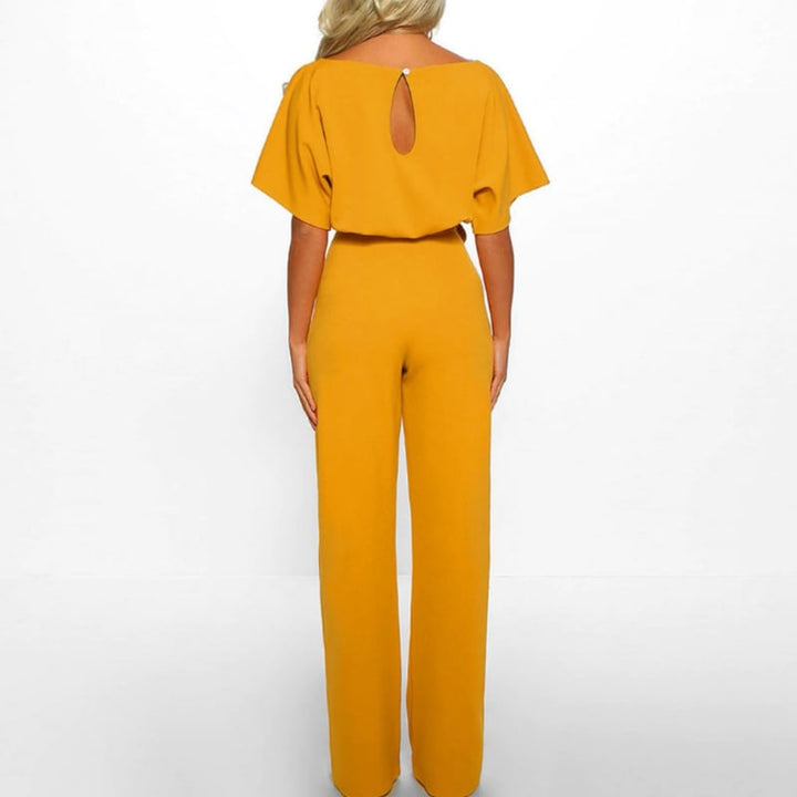 Woman wearing the Celeste wide-leg batwing jumpsuit in classic navy blue