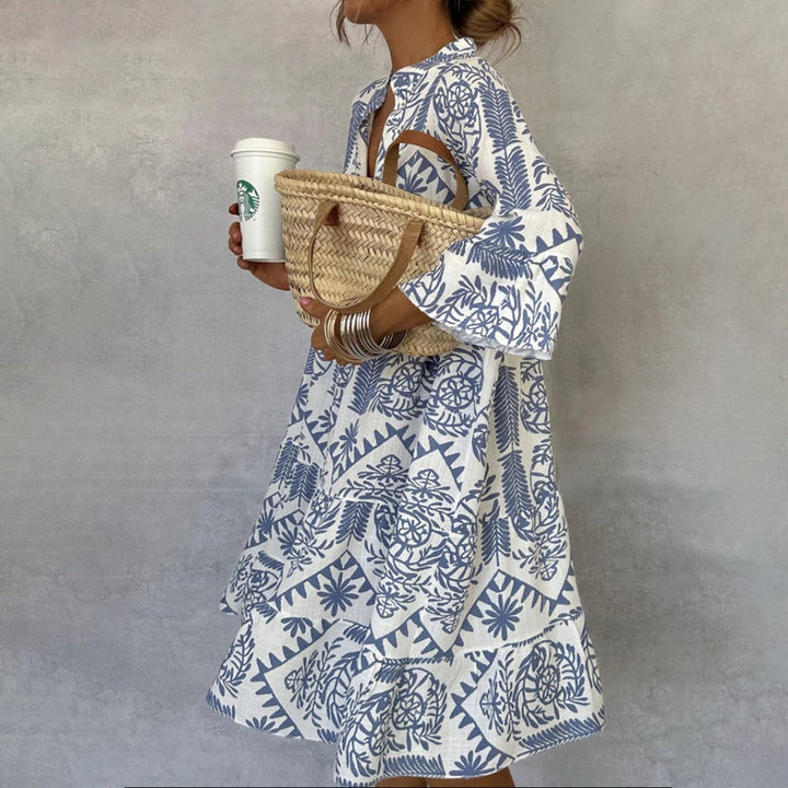 Front view of the Celeste blue-and-white boho print V-neck swing dress with 3/4 flared sleeves and tiered A-line skirt