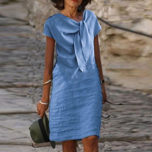 Side view of the Celeste short sleeve midi dress in blue showing the clean, straight silhouette