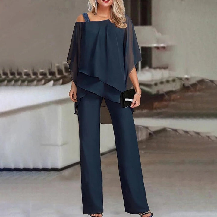 Close-up of the Celeste jumpsuit cold shoulder cutout and layered chiffon fabric detail