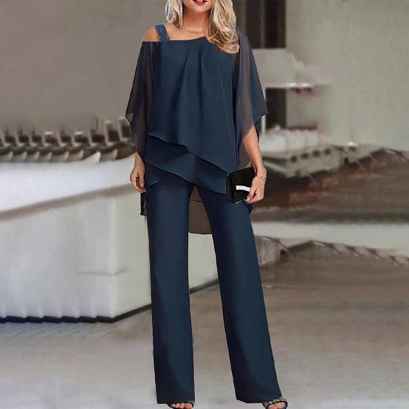 Close-up of the Celeste jumpsuit cold shoulder cutout and layered chiffon fabric detail