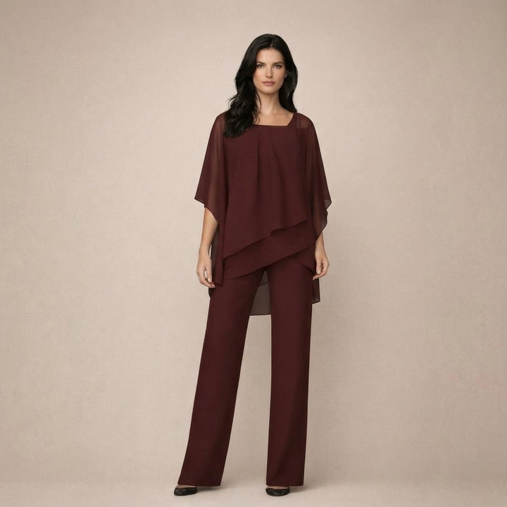 Woman styled in the Celeste burgundy off shoulder top and wide leg pants set for an evening look