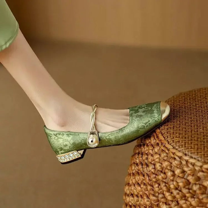 Celeste mary jane shoes in sage green from behind, highlighting glitter block heel detail