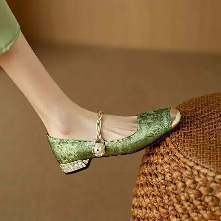 Celeste mary jane shoes in sage green from behind, highlighting glitter block heel detail