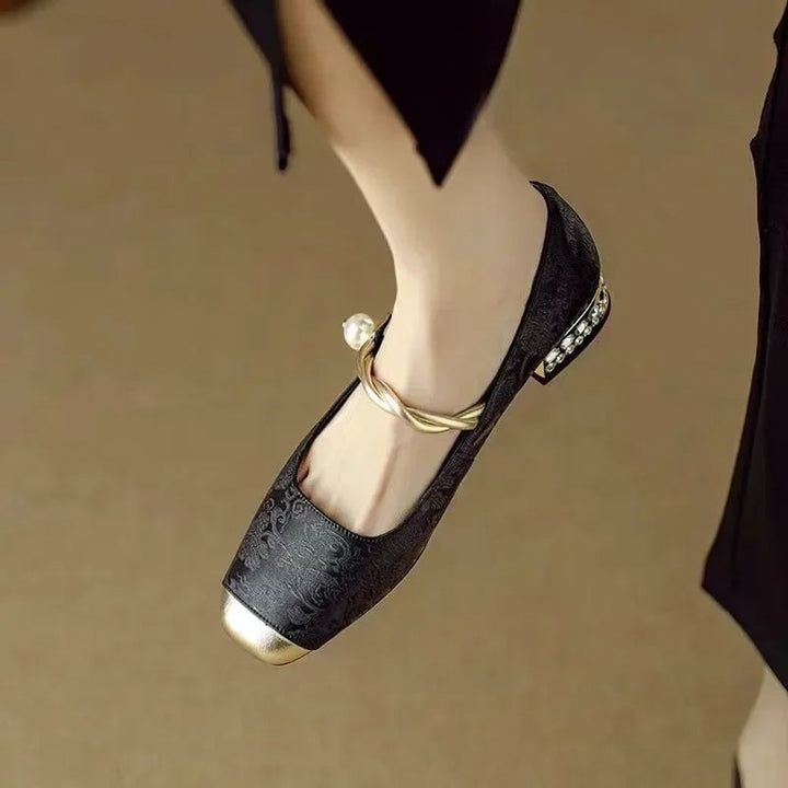 Celeste pearl strap mary jane shoes in black with metallic detailing, front view
