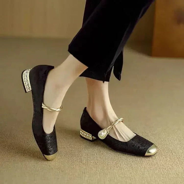 Celeste mary jane shoes in black, side profile showing glitter block heel and pearl strap