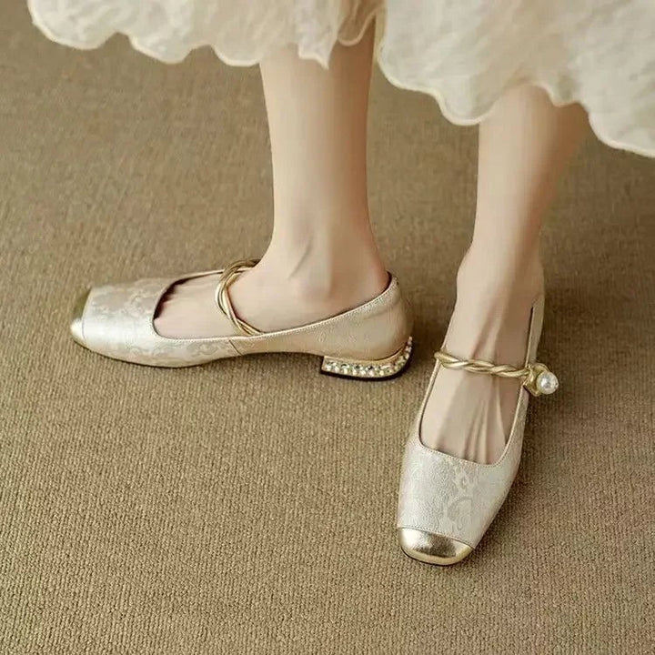 Close-up of pearl strap detail on beige Celeste mary jane shoes