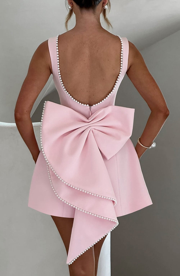 Back view of Celeste mini dress in black with statement pearl bow detail