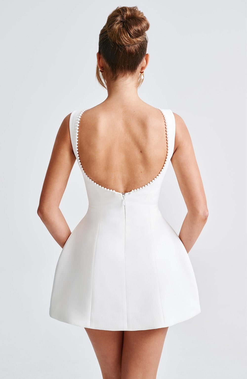 Side profile of Celeste A-line mini dress showing the flared skirt and tailored waist