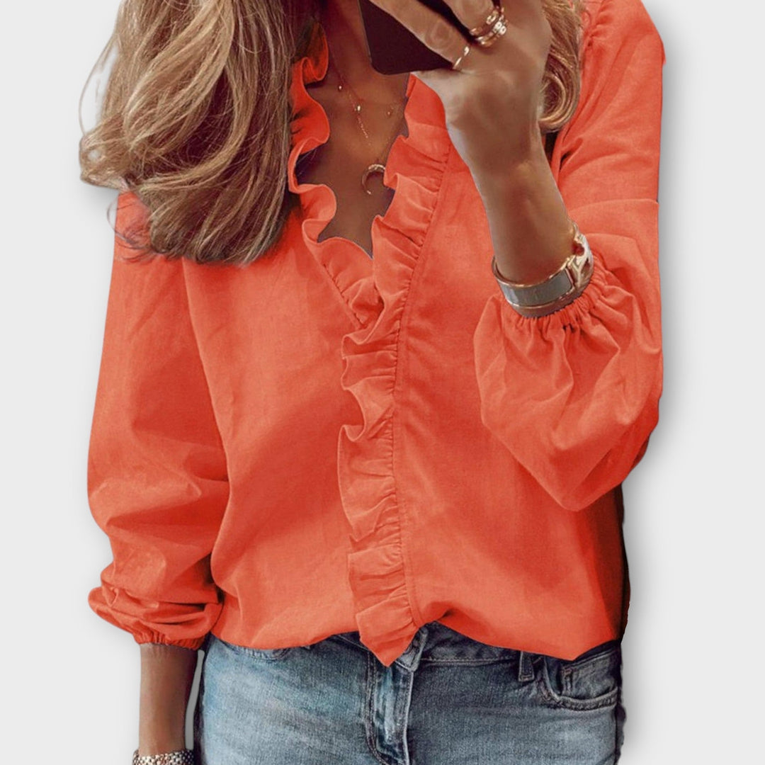 Front view of the Celeste mint green ruffle blouse styled with tailored trousers