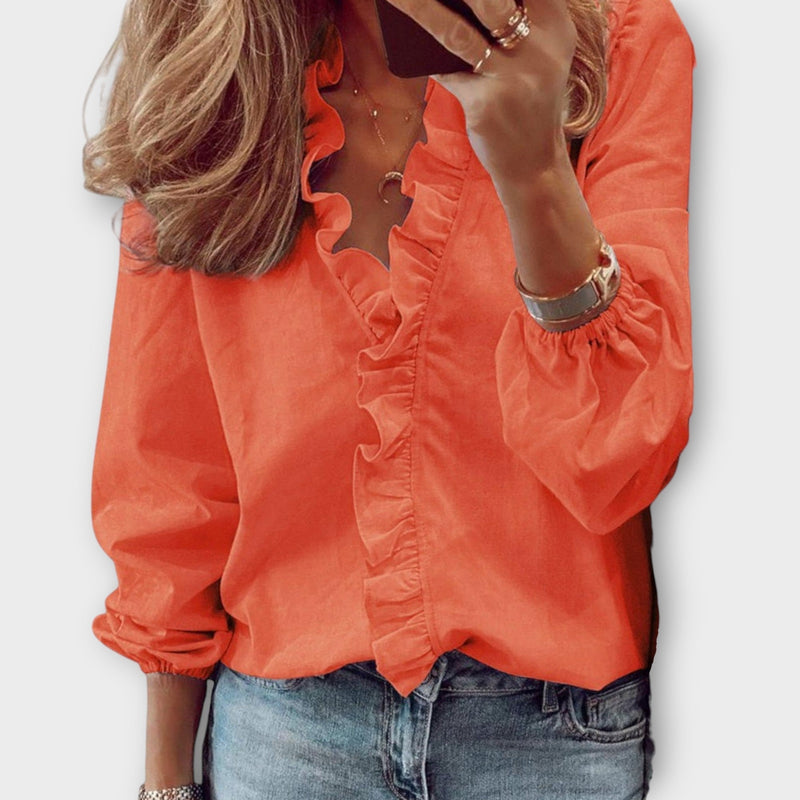 Front view of the Celeste mint green ruffle blouse styled with tailored trousers
