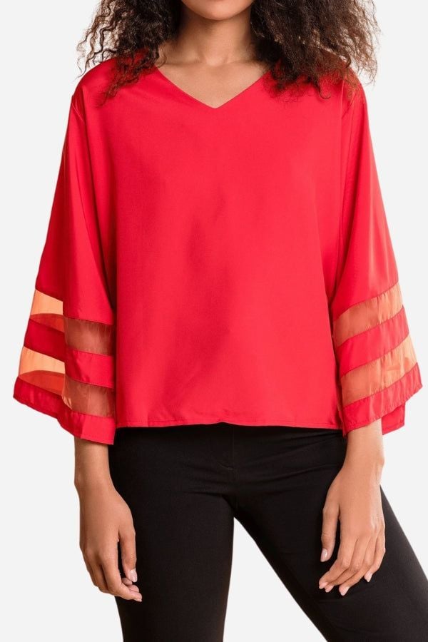 Close-up of the sheer mesh stripe panel detail on the bell sleeve of the Celeste blouse in white