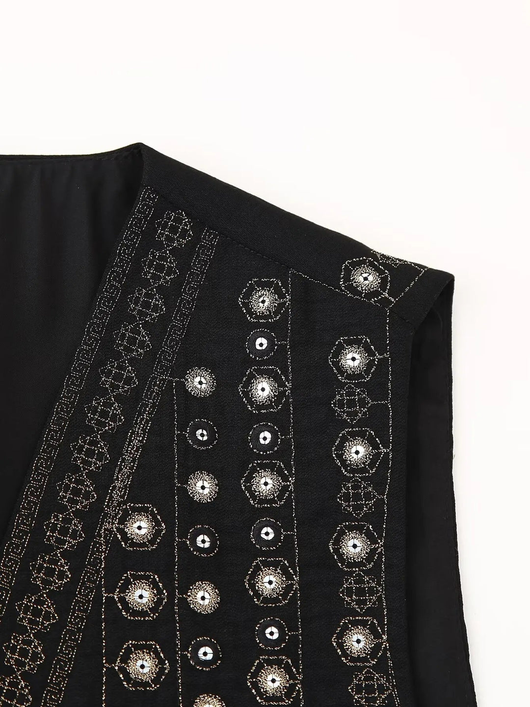 Side profile of black cropped sequin vest highlighting sleeveless open-front design