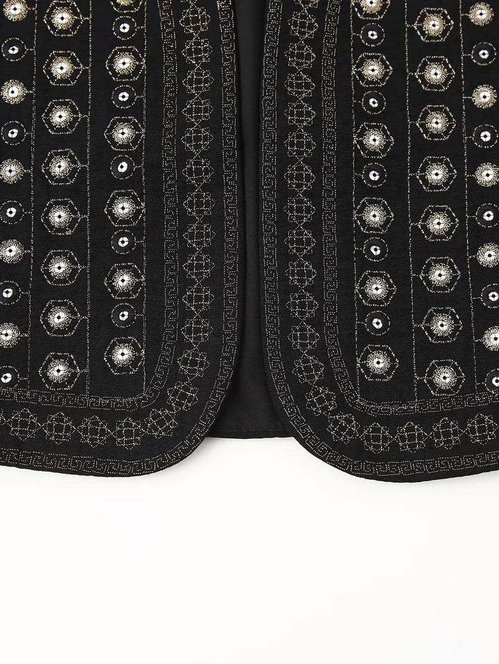 Model wearing black sequin vest at festival-style outdoor setting