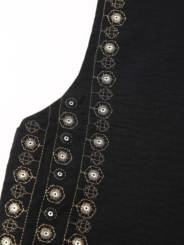 Full-length shot of model in black sequin boho vest over flowy dress