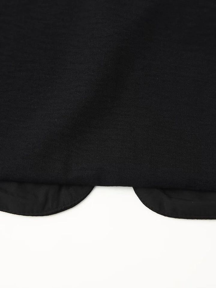 Close-up of vest neckline and open-front edge with sequin detailing