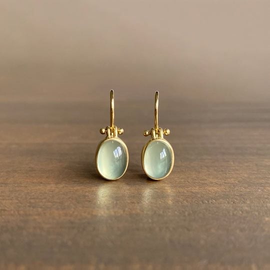 Vintage-inspired green moonstone drop earrings with a luminous stone and elegant silhouette