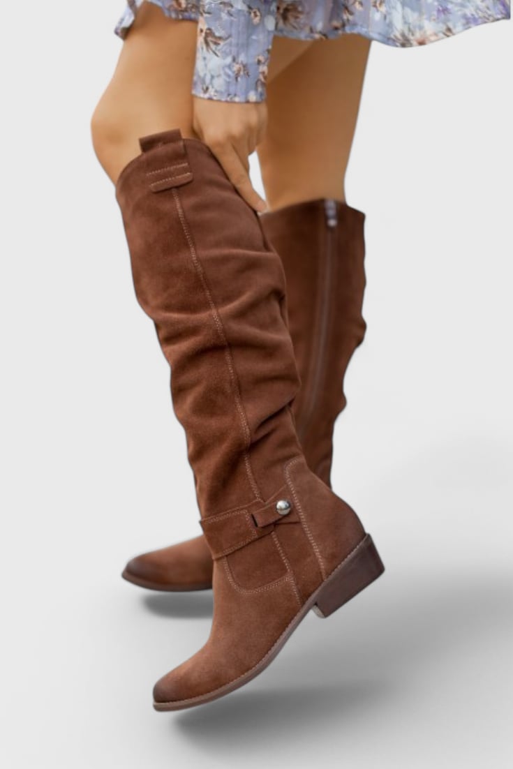 Front view of Celine retro-inspired high boots in dark brown with a sleek elongated silhouette