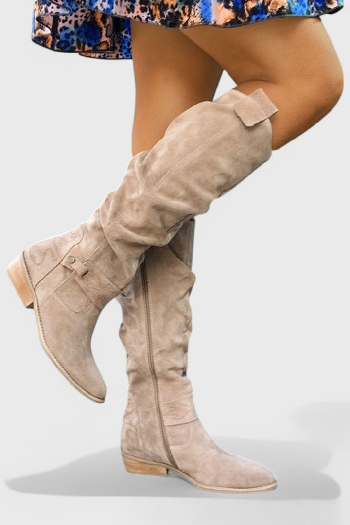 Brown retro-inspired high boots paired with skinny jeans for a city-chic outfit